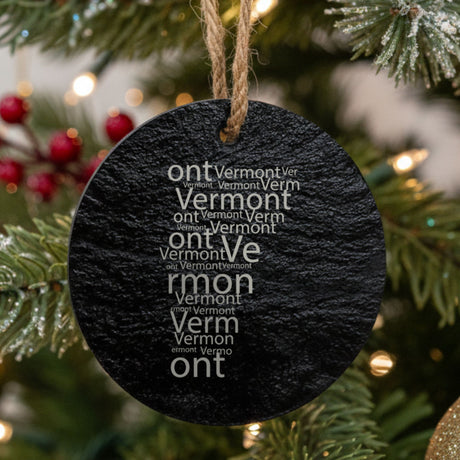 Vermont round slate Christmas ornament engraved with a word cloud of repeating Vermont text