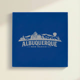 Close up of the Albuquerque, New Mexico skyline engraved on Blue leatherette