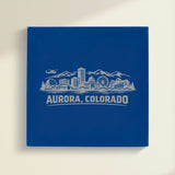 Close up of the Aurora, Colorado skyline engraved on Blue leatherette