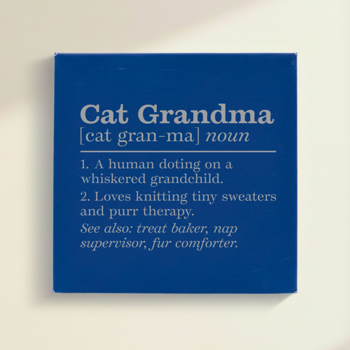 Close-up of the blue leatherette wall sign engraved with the Cat Grandma dictionary definition