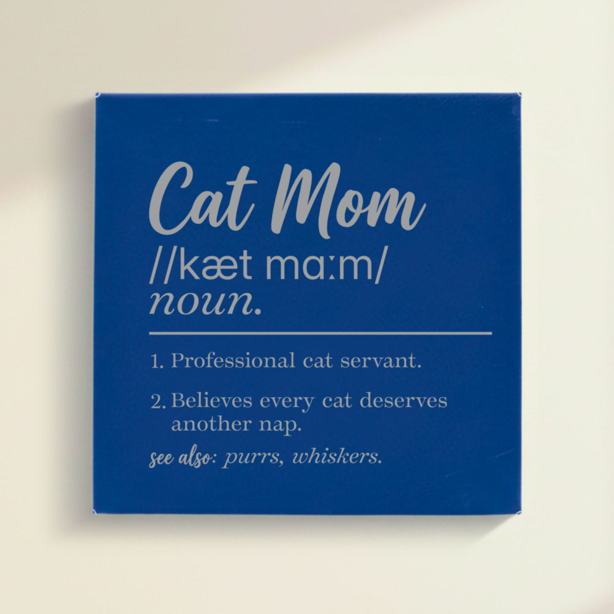 Close-up of the blue leatherette wall sign engraved with the Cat Mom dictionary definition