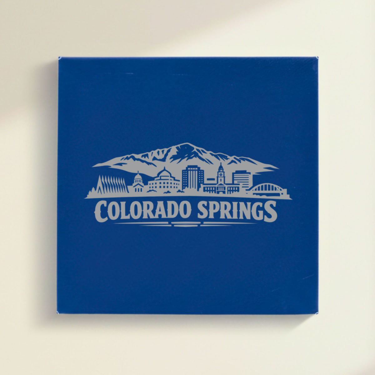 Close up of the Colorado Springs, Colorado skyline engraved on Blue leatherette