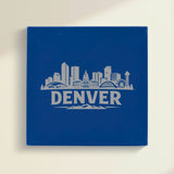 Close up of the Denver, Colorado skyline engraved on Blue leatherette