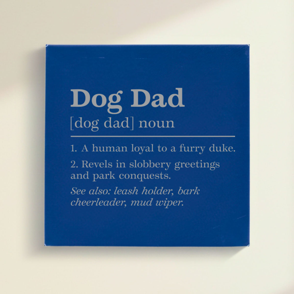 Close-up of the blue leatherette wall sign engraved with the Dog Dad dictionary definition