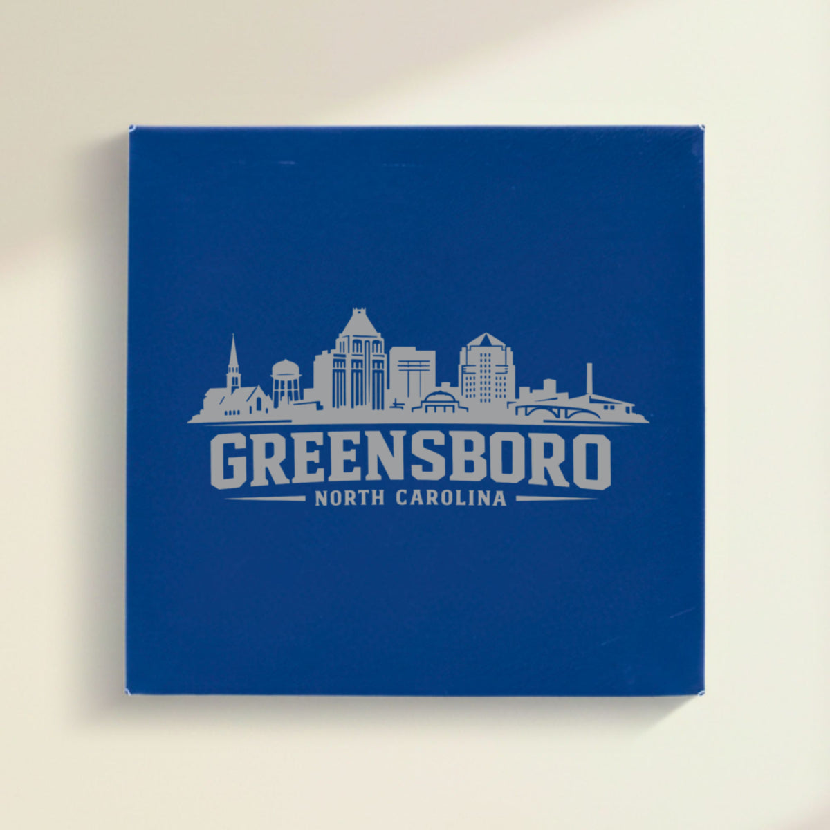Close up of the Greensboro, North Carolina skyline engraved on Blue leatherette