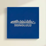 Close up of the Honolulu, Hawaii skyline engraved on Blue leatherette
