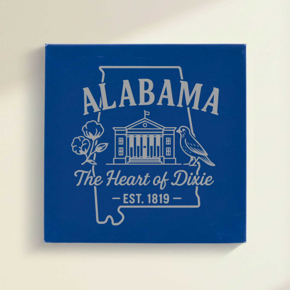 Close up of the Alabama design engraved on Blue leatherette: the capitol building, a cotton boll and a yellowhammer, "The Heart of Dixie", EST. 1819