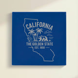 Close up of the California design engraved on Blue leatherette: palm trees, the ocean and a grizzly bear, "The Golden State", EST. 1850