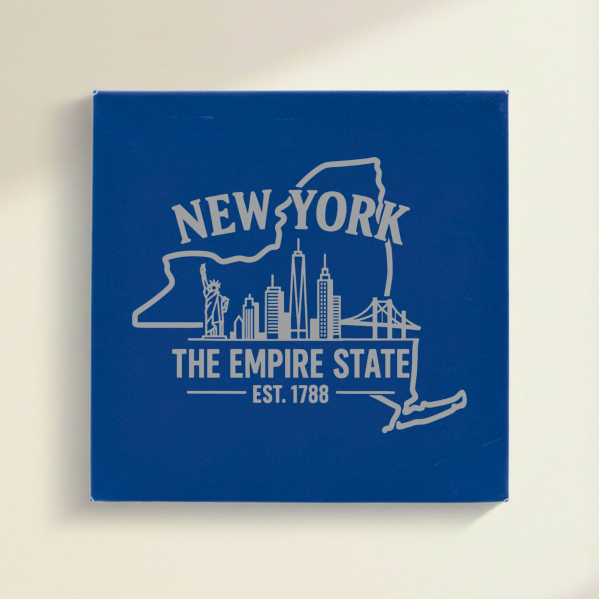 Close up of the New York design engraved on Blue leatherette: the Statue of Liberty and the Manhattan skyline, "The Empire State", EST. 1788