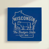 Close up of the Wisconsin design engraved on Blue leatherette: a dairy cow and a wedge of cheese, "The Badger State", EST. 1848