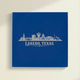 Close up of the Laredo, Texas skyline engraved on Blue leatherette