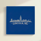 Close up of the Lincoln, Nebraska skyline engraved on Blue leatherette
