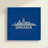 Close up of the Omaha, Nebraska skyline engraved on Blue leatherette