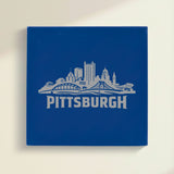 Close up of the Pittsburgh, Pennsylvania skyline engraved on Blue leatherette