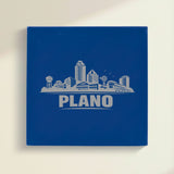 Close up of the Plano, Texas skyline engraved on Blue leatherette