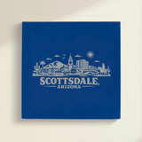 Close up of the Scottsdale, Arizona skyline engraved on Blue leatherette