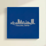 Close up of the Toledo, Ohio skyline engraved on Blue leatherette