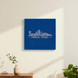 Blue leatherette wall sign engraved with the Frisco, Texas skyline, hanging on a wall