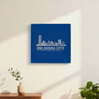 Blue leatherette wall sign engraved with the Oklahoma City, Oklahoma skyline, hanging on a wall