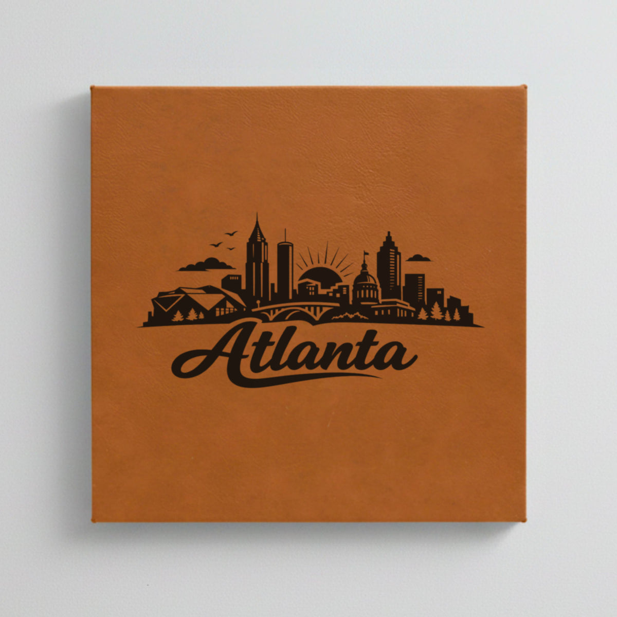 Close up of the Atlanta, Georgia skyline engraved on Brown leatherette