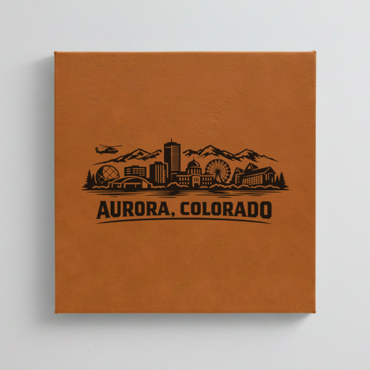 Close up of the Aurora, Colorado skyline engraved on Brown leatherette