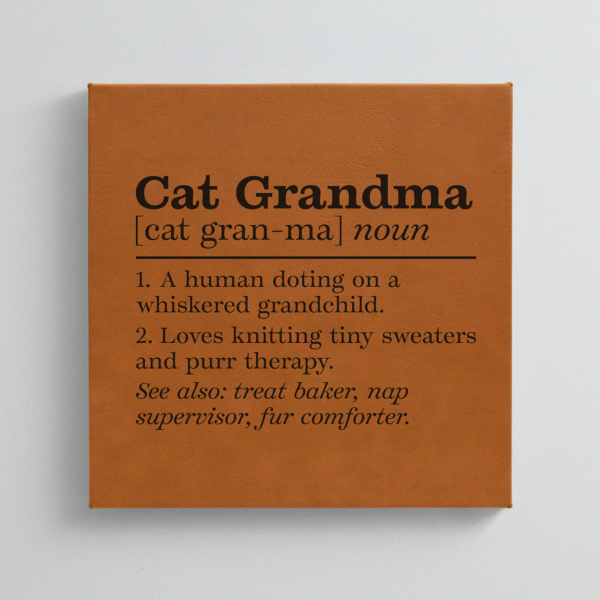 Close-up of the brown leatherette wall sign engraved with the Cat Grandma dictionary definition