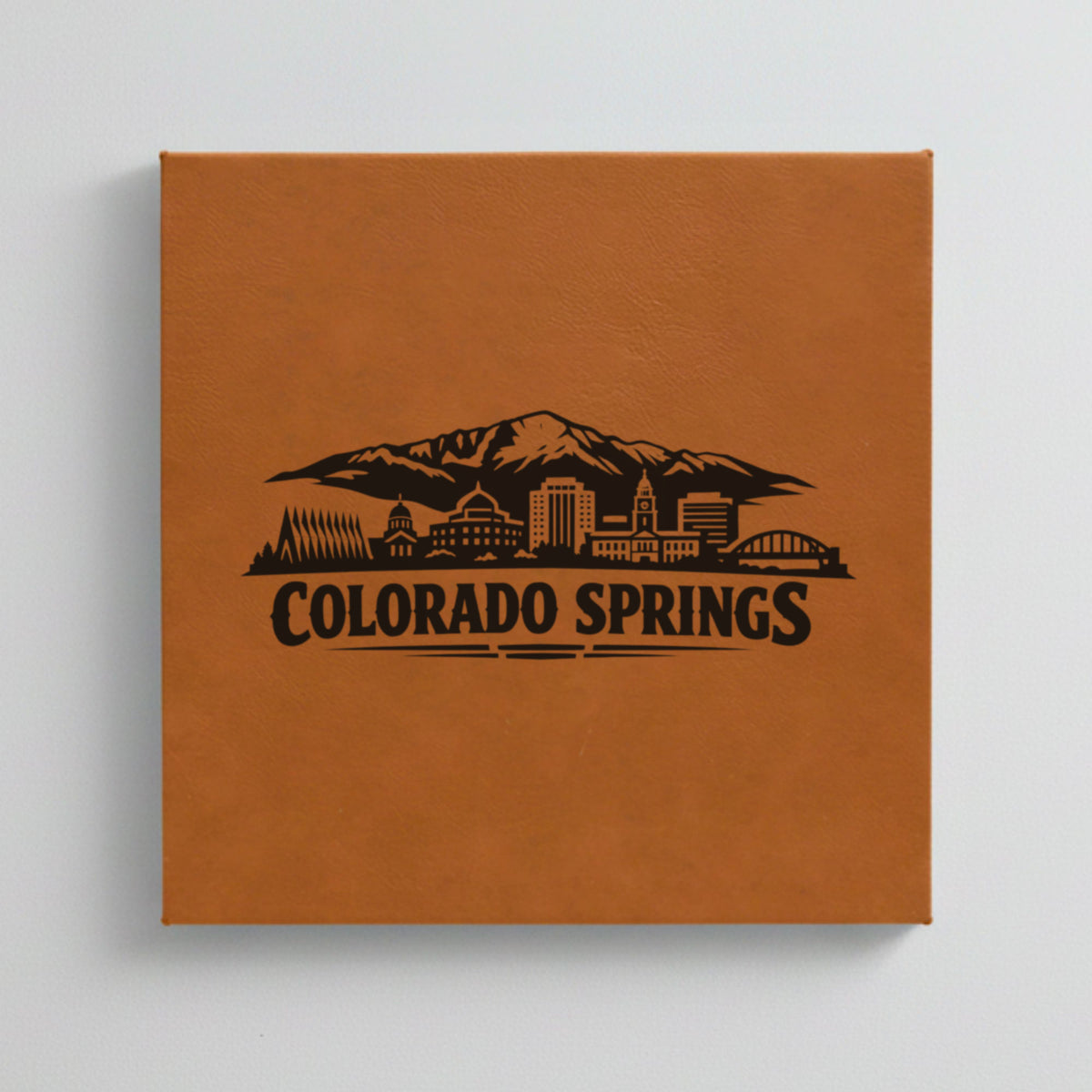 Close up of the Colorado Springs, Colorado skyline engraved on Brown leatherette
