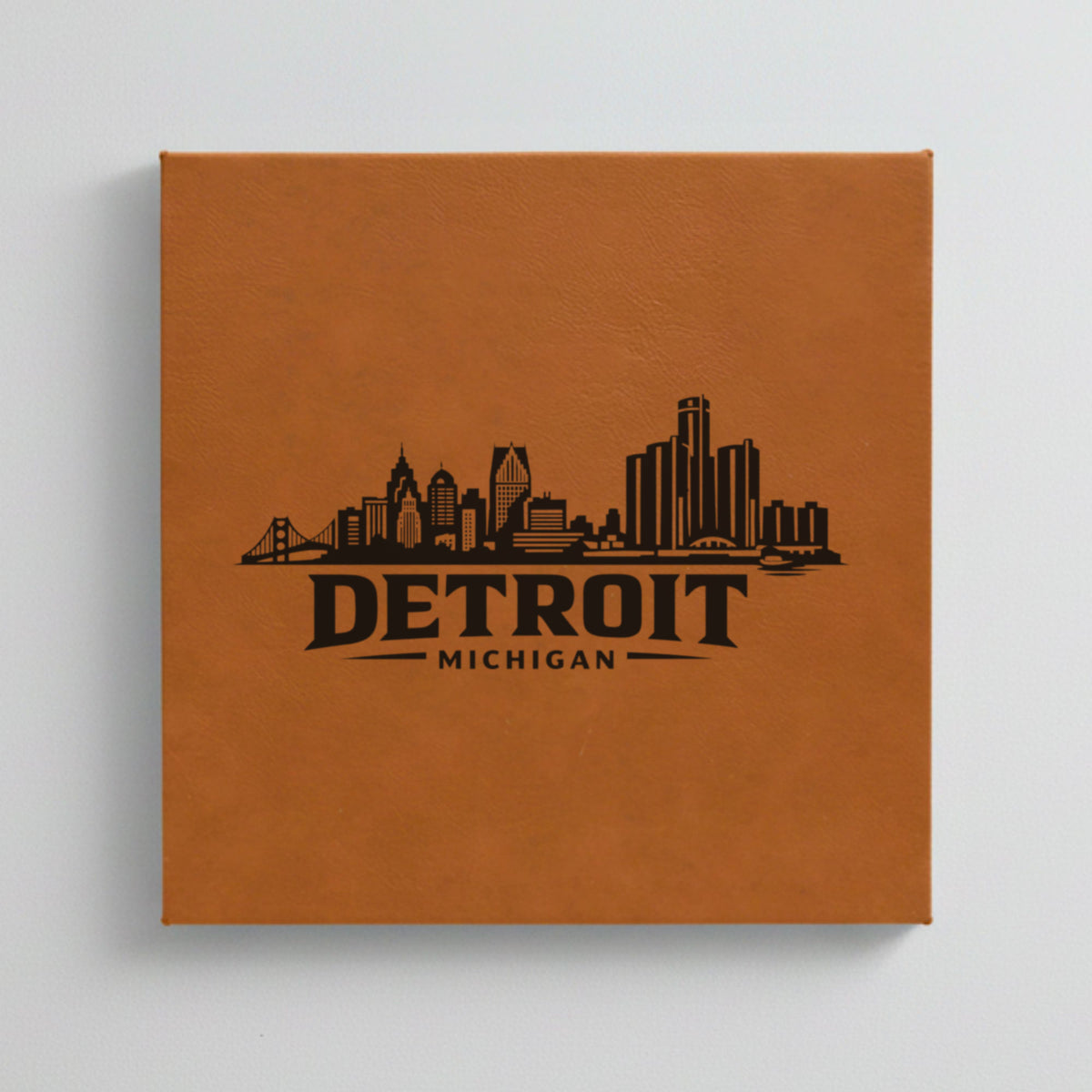Close up of the Detroit, Michigan skyline engraved on Brown leatherette