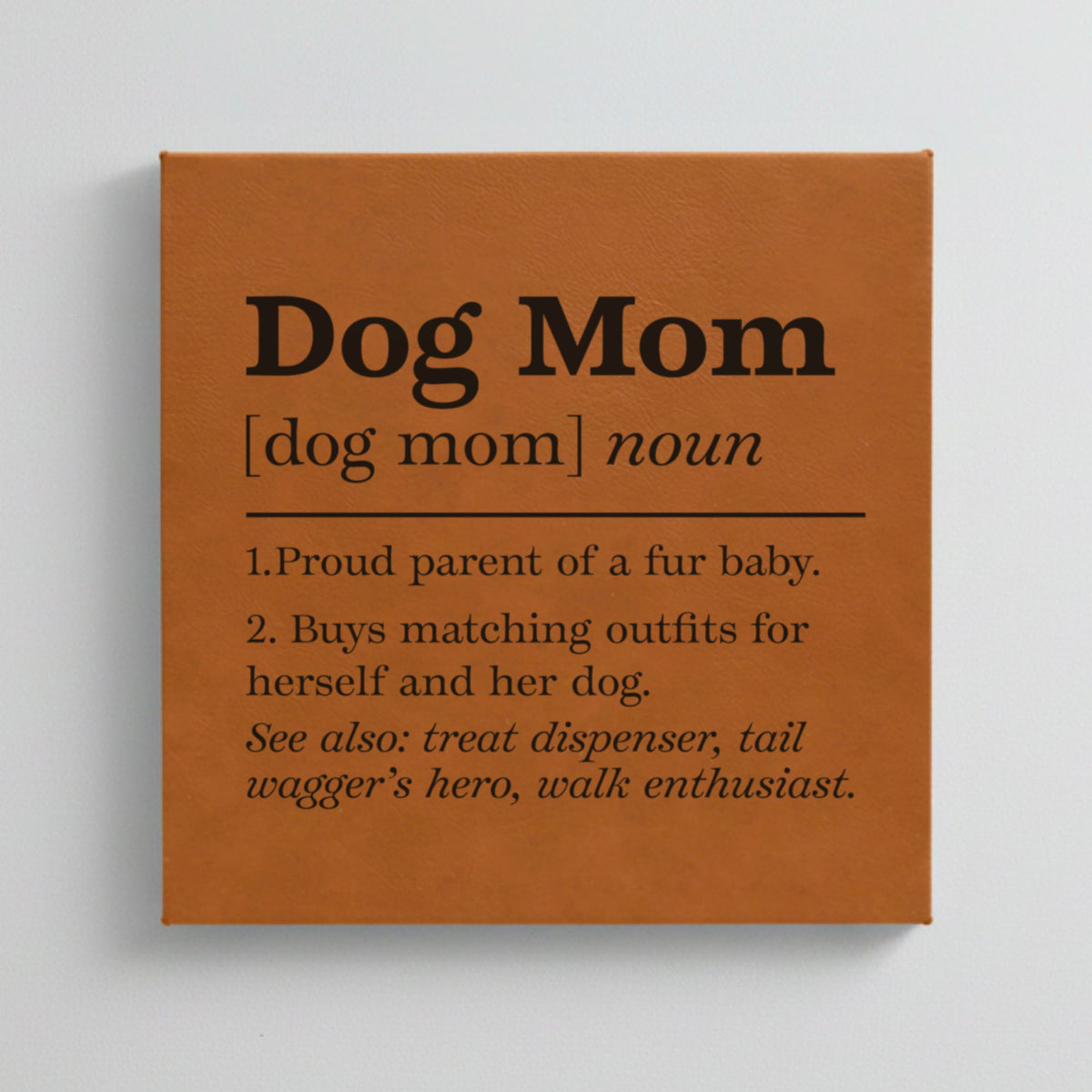 Close-up of the brown leatherette wall sign engraved with the Dog Mom dictionary definition