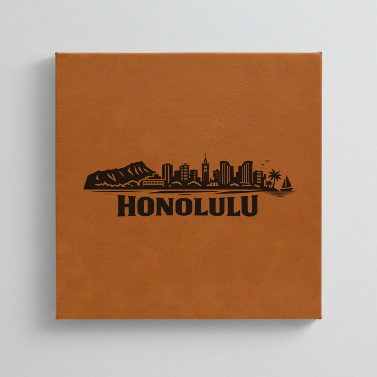Close up of the Honolulu, Hawaii skyline engraved on Brown leatherette