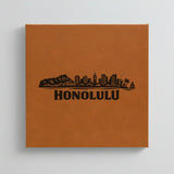 Close up of the Honolulu, Hawaii skyline engraved on Brown leatherette
