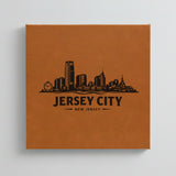 Close up of the Jersey City, New Jersey skyline engraved on Brown leatherette