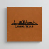 Close up of the Laredo, Texas skyline engraved on Brown leatherette