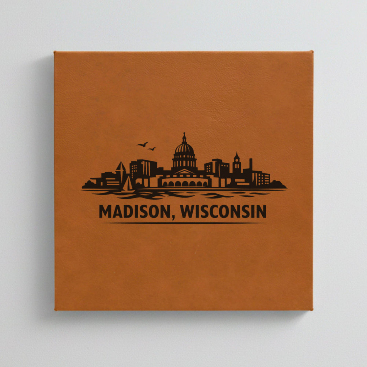 Close up of the Madison, Wisconsin skyline engraved on Brown leatherette