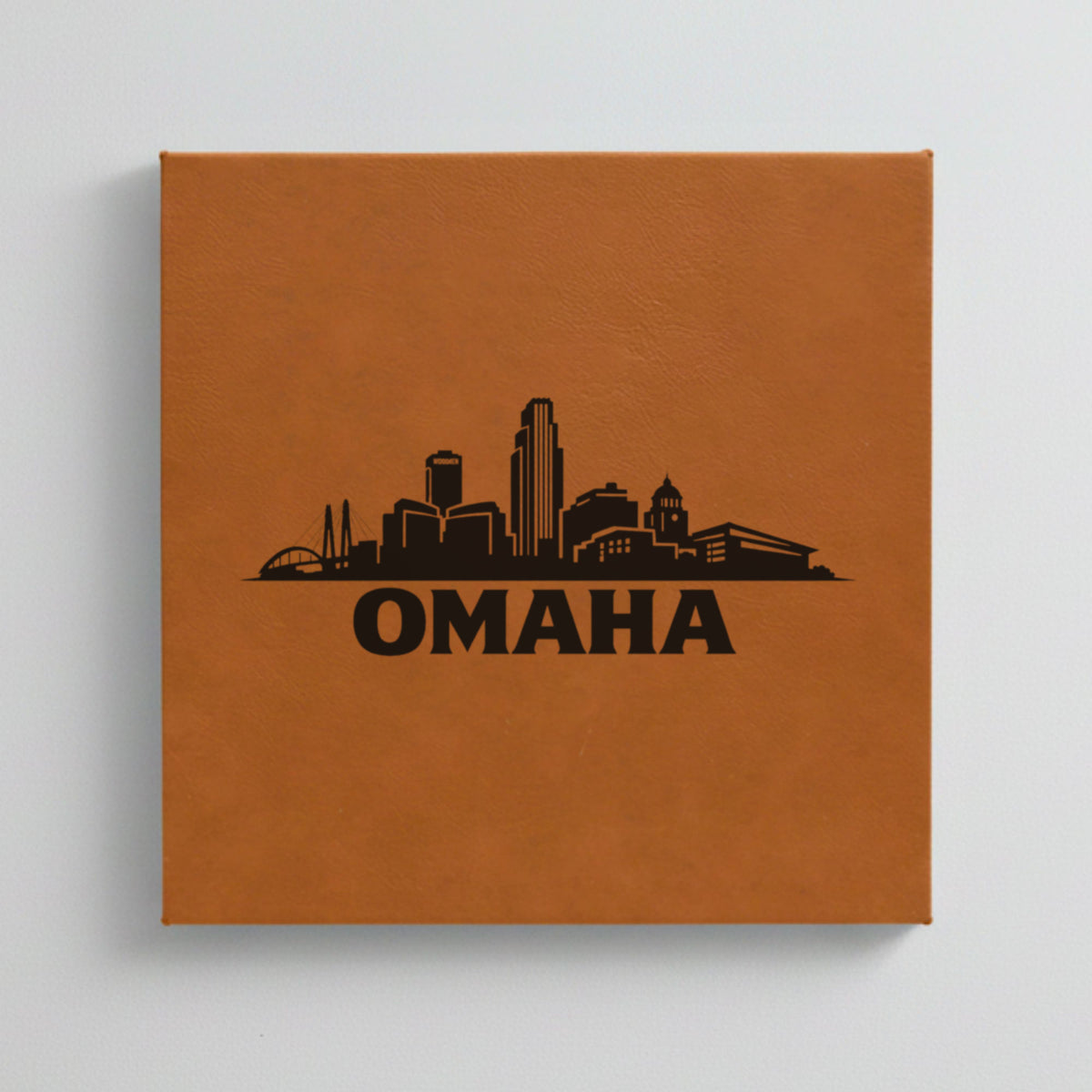 Close up of the Omaha, Nebraska skyline engraved on Brown leatherette