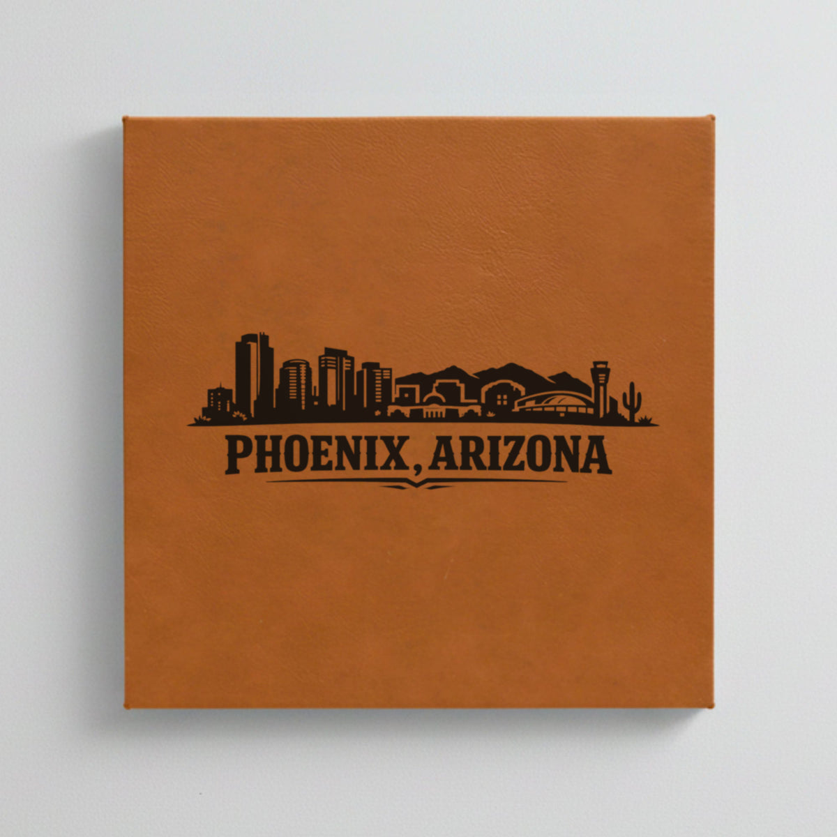 Close up of the Phoenix, Arizona skyline engraved on Brown leatherette