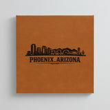 Close up of the Phoenix, Arizona skyline engraved on Brown leatherette