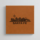 Close up of the Santa Fe, New Mexico skyline engraved on Brown leatherette