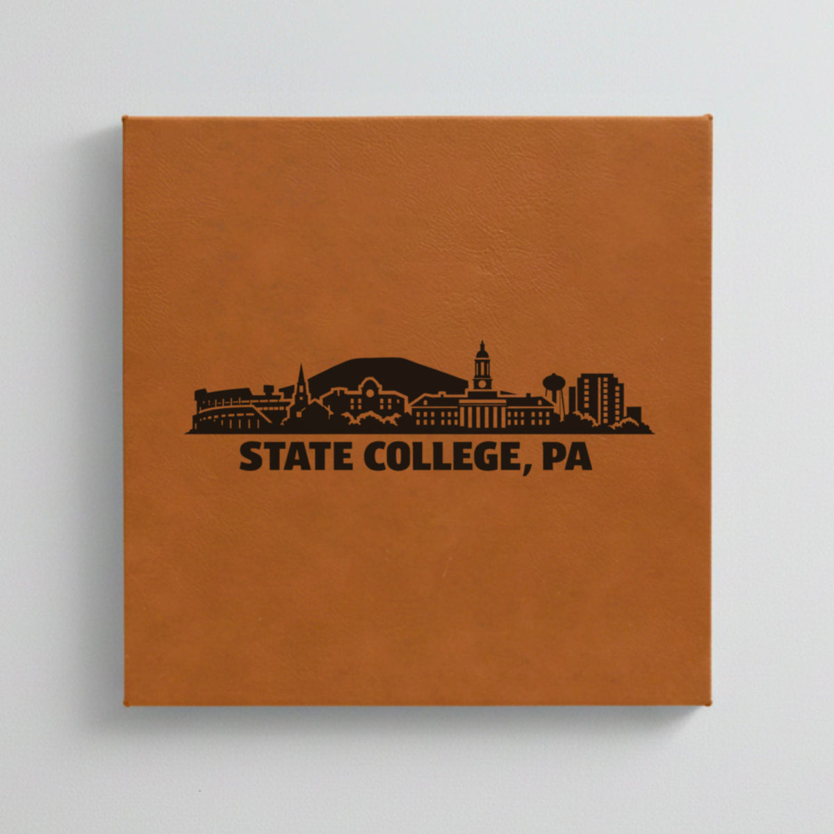 Close up of the State College, Pennsylvania skyline engraved on Brown leatherette