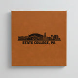 Close up of the State College, Pennsylvania skyline engraved on Brown leatherette