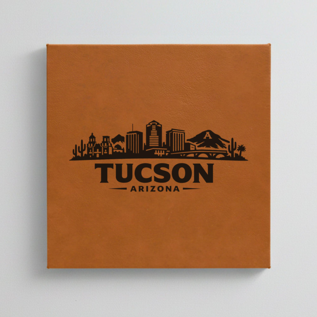 Close up of the Tucson, Arizona skyline engraved on Brown leatherette