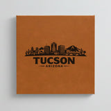 Close up of the Tucson, Arizona skyline engraved on Brown leatherette
