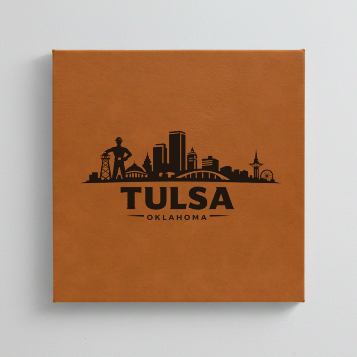 Close up of the Tulsa, Oklahoma skyline engraved on Brown leatherette