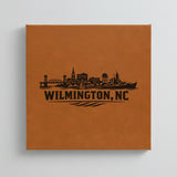 Close up of the Wilmington, North Carolina skyline engraved on Brown leatherette