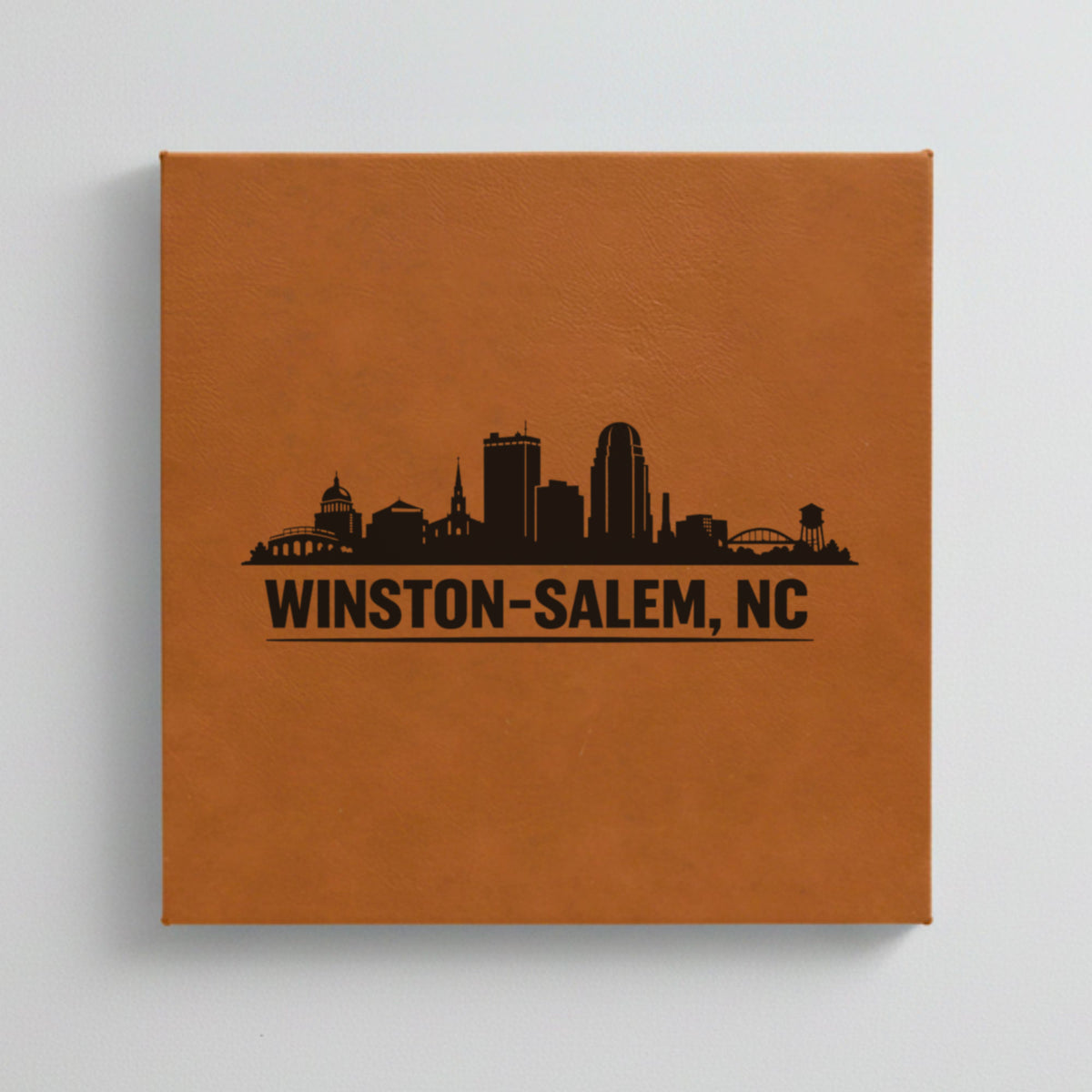 Close up of the Winston-Salem, North Carolina skyline engraved on Brown leatherette
