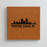 Close up of the Winston-Salem, North Carolina skyline engraved on Brown leatherette