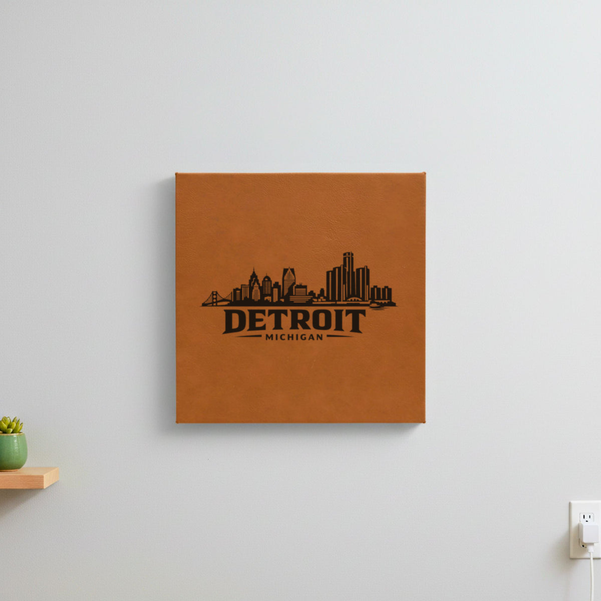 Brown leatherette wall sign engraved with the Detroit, Michigan skyline, hanging on a wall