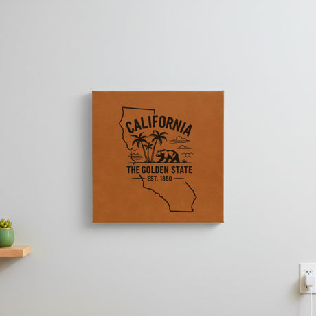 Brown leatherette wall sign engraved with a California design of palm trees, the ocean and a grizzly bear, hanging on a wall