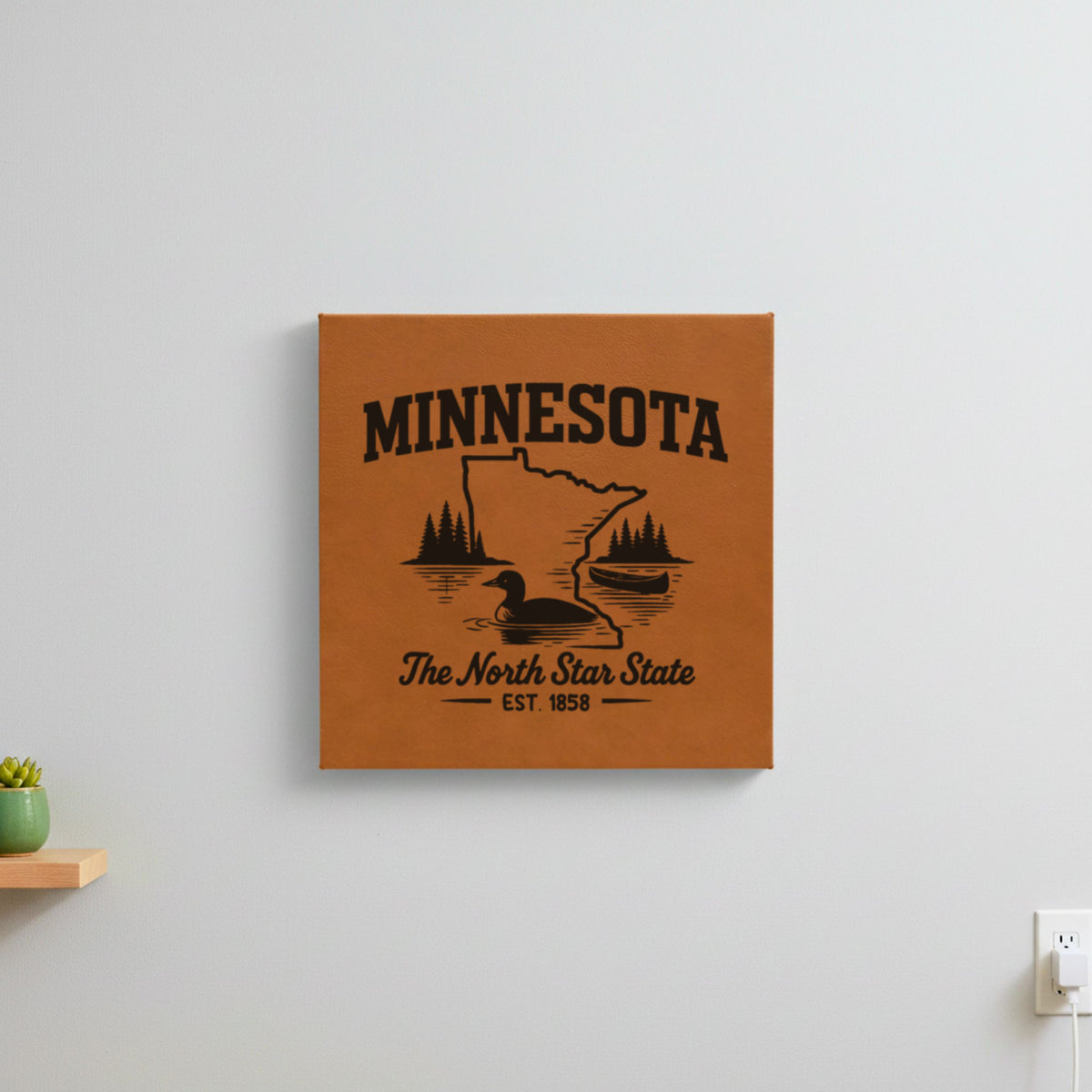 Brown leatherette wall sign engraved with a Minnesota design of a loon, a canoe and lakeside pines, hanging on a wall