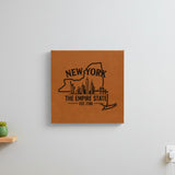 Brown leatherette wall sign engraved with a New York design of the Statue of Liberty and the Manhattan skyline, hanging on a wall